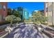 Beautiful courtyard featuring modern architecture, benches, potted plants, and lovely landscaping at 26 E Serene Ave # 124, Las Vegas, NV 89123