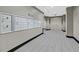 Interior hallway with mailboxes, leading to double doors and featuring neutral walls and flooring at 26 E Serene Ave # 124, Las Vegas, NV 89123