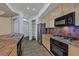 Modern kitchen with stainless steel appliances, custom cabinets, and granite countertops at 26 E Serene Ave # 124, Las Vegas, NV 89123