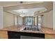 An open concept kitchen and living space with granite countertops, modern appliances, and tile floors at 26 E Serene Ave # 124, Las Vegas, NV 89123