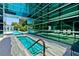 Luxurious pool and spa area with modern glass architecture and comfortable lounge seating at 26 E Serene Ave # 124, Las Vegas, NV 89123