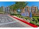 Entrance to Manhattan Condominiums, featuring lush landscaping and a welcoming sign at 26 E Serene Ave # 124, Las Vegas, NV 89123