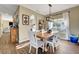 Bright dining room with a wooden table and white chairs, near the kitchen at 2875 Skowhegan Dr, Henderson, NV 89074