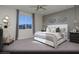 Bright main bedroom with white bed, large windows and mountain views at 329 S Orleans St # Lot 1, Henderson, NV 89015