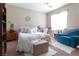 Bright bedroom with a bed, dresser, bookshelf, desk, and a comfortable blue chair at 4625 Centisimo Dr # 202, North Las Vegas, NV 89084