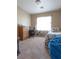 This bedroom features carpet, a desk, and a bright window with a beanbag chair at 4625 Centisimo Dr # 202, North Las Vegas, NV 89084