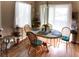 Sun-lit dining area with wood-look floors, a round table and chairs, and sheer curtains at 4625 Centisimo Dr # 202, North Las Vegas, NV 89084