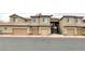 An exterior view of a multi-unit building featuring garages and staircases at 4625 Centisimo Dr # 202, North Las Vegas, NV 89084