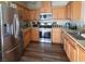 Modern kitchen with stainless steel appliances, wood flooring, and ample storage at 4625 Centisimo Dr # 202, North Las Vegas, NV 89084