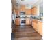 Updated kitchen featuring stainless steel appliances, wood flooring, and bright lighting at 4625 Centisimo Dr # 202, North Las Vegas, NV 89084