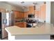 Well-lit kitchen with stainless steel appliances, wooden cabinets, and ample counter space at 4625 Centisimo Dr # 202, North Las Vegas, NV 89084