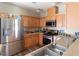 Spacious kitchen with stainless steel appliances, wood cabinets, and ample counter space at 4625 Centisimo Dr # 202, North Las Vegas, NV 89084