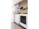 A laundry room with a modern washer and dryer set, complete with overhead shelving at 4625 Centisimo Dr # 202, North Las Vegas, NV 89084