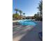 Community pool with lounge chairs and patio at 4625 Centisimo Dr # 202, North Las Vegas, NV 89084