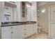 Double vanity bathroom with granite countertop and large mirror at 50 Aura De Blanco St # 17204, Henderson, NV 89074