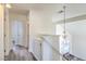 Upstairs hallway with light-colored cabinets and wood-look floors at 5059 Shadow Boxer Ct, Las Vegas, NV 89142