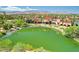 Aerial view of community buildings surrounding a serene lake with lush greenery and distant mountain views at 5201 Progresso St, Las Vegas, NV 89135