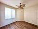 Bright bedroom features wood floors, ceiling fan, and window with blinds at 5201 Progresso St, Las Vegas, NV 89135