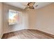Cozy bedroom features wood floors and ceiling fan at 5201 Progresso St, Las Vegas, NV 89135