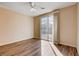 Bright bedroom features wood floors, ceiling fan, and sliding glass doors to the outside at 5201 Progresso St, Las Vegas, NV 89135