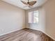 This bedroom features wood-look floors, a ceiling fan, and a window for natural light at 5201 Progresso St, Las Vegas, NV 89135