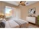 Stylishly staged bedroom with a large window and ceiling fan at 5201 Progresso St, Las Vegas, NV 89135