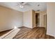Cozy bedroom features wood floors, ceiling fan, and ensuite bathroom at 5201 Progresso St, Las Vegas, NV 89135