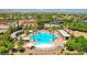 Inviting community pool area with ample seating, surrounded by mature palm trees and manicured landscaping at 5201 Progresso St, Las Vegas, NV 89135