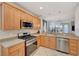 Modern kitchen with stainless steel appliances and light wood cabinets at 5201 Progresso St, Las Vegas, NV 89135