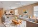 Cozy living room with gray furniture, a stylish rug, and a ceiling fan at 5201 Progresso St, Las Vegas, NV 89135