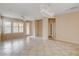 Open living space with tile flooring, ceiling fan, neutral paint and modern light fixture at 5201 Progresso St, Las Vegas, NV 89135