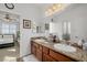 Double vanity bathroom with granite countertop and large mirror at 537 Blanche Ct, Henderson, NV 89052