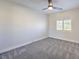Well-lit bedroom with ceiling fan and gray carpeting at 5423 San Florentine Ave, Las Vegas, NV 89141