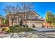 Two-story house with a two-car garage and lush green lawn at 5423 San Florentine Ave, Las Vegas, NV 89141