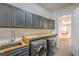 Laundry room with gray cabinets and wood counter at 5423 San Florentine Ave, Las Vegas, NV 89141