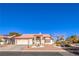 Single-story house with red tile roof, landscaping, and a two-car garage at 5604 Ocean Pines Cir, Las Vegas, NV 89130