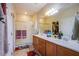 Double vanity bathroom with a large mirror, shower, and modern fixtures at 5944 Saddle Horse Ave, Las Vegas, NV 89122