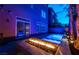 Night view of a modern backyard pool and fire pit at 5956 Lambert Bridge Ave, Las Vegas, NV 89139