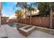 Lush backyard oasis with a built-in fire pit and a modern pool at 5956 Lambert Bridge Ave, Las Vegas, NV 89139