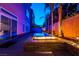 Night view of a modern backyard pool and fire pit at 5956 Lambert Bridge Ave, Las Vegas, NV 89139