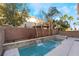 Daytime view of a modern backyard pool and fire pit at 5956 Lambert Bridge Ave, Las Vegas, NV 89139