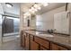 Bathroom with granite countertop, double sink, and shower/tub combo at 5956 Lambert Bridge Ave, Las Vegas, NV 89139