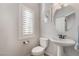 Clean and bright bathroom with pedestal sink and shutters at 5956 Lambert Bridge Ave, Las Vegas, NV 89139