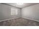 Simple bedroom with gray walls and carpet flooring at 5956 Lambert Bridge Ave, Las Vegas, NV 89139