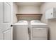 Bright laundry room with washer, dryer, and shelving at 5956 Lambert Bridge Ave, Las Vegas, NV 89139