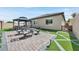 Relaxing backyard oasis with gazebo, patio furniture, and landscaped lawn at 6160 Lautman Ridge Ct, Las Vegas, NV 89141