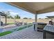 Spacious backyard with covered patio, hot tub, gazebo, and artificial turf at 6160 Lautman Ridge Ct, Las Vegas, NV 89141