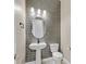 Modern bathroom with gray tile and pedestal sink at 6160 Lautman Ridge Ct, Las Vegas, NV 89141