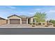 Single-story house with two-car garage, landscaping, and a neutral color scheme at 6160 Lautman Ridge Ct, Las Vegas, NV 89141