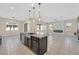 Modern kitchen with a large island, stainless steel appliances, and dark cabinetry at 6160 Lautman Ridge Ct, Las Vegas, NV 89141